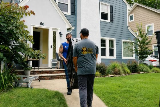 Teddy Bear Moving crew carrying protected furniture during a home move