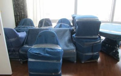 Furniture wrapped in protective moving blankets by Teddy Bear Moving
